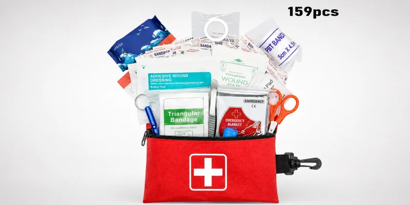 Open military-style first aid kit displaying various medical